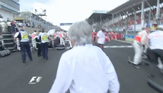 2008 Brazilian GP - Bernie running from the rain